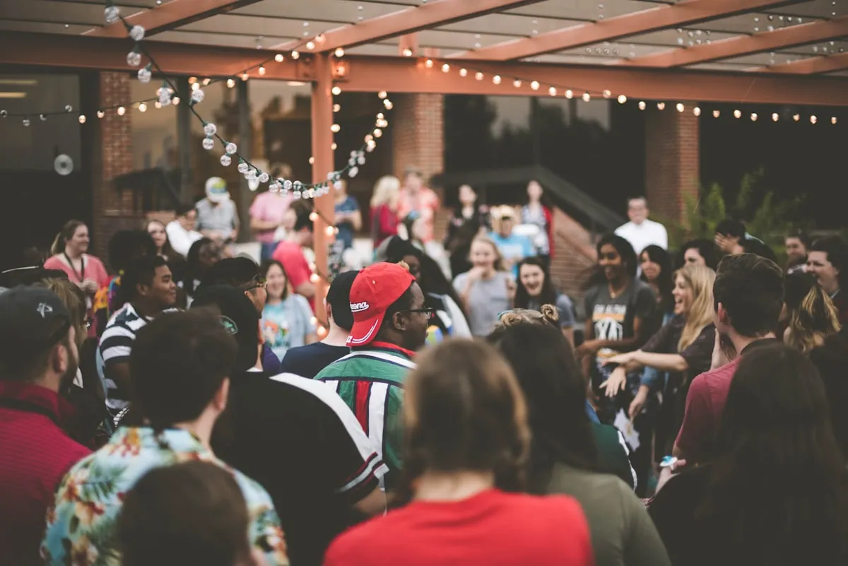 Guests laughing together in a candid celebration crowd